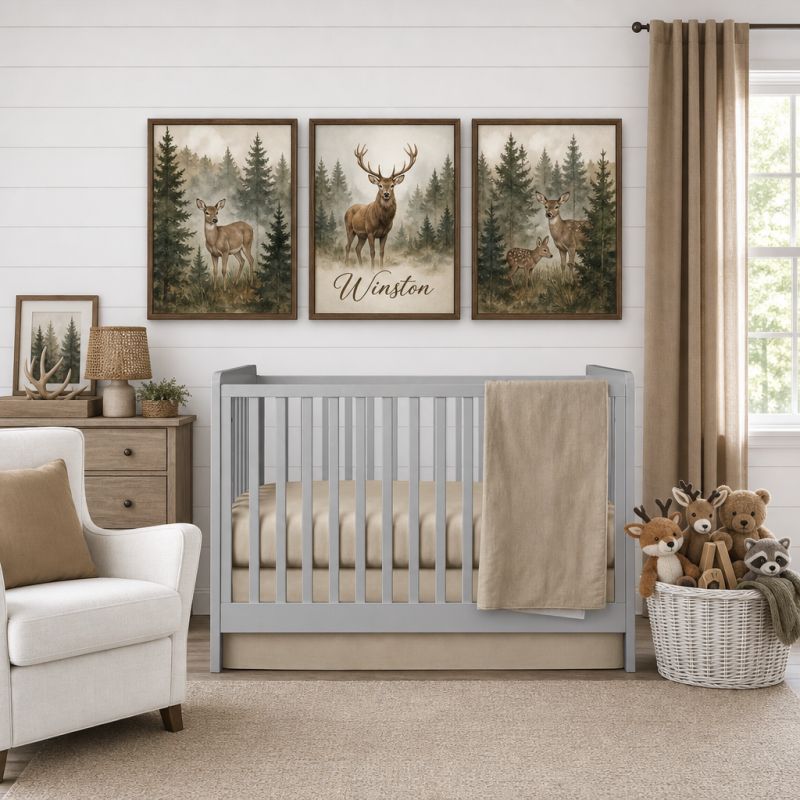A styled nursery scene with a light gray crib, beige bedding and throw blanket, a white armchair, a wooden dresser, and three framed deer wall art prints above the crib. The center print reads 'Winston'.
 Baby Boy Crib Bedding Tan - The Creative Raccoon 