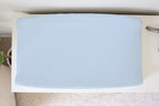 a changing pad cover in light blue over a change pad on a white dresser. 
Baby Blue Changing Pad Cover - The Creative Raccoon