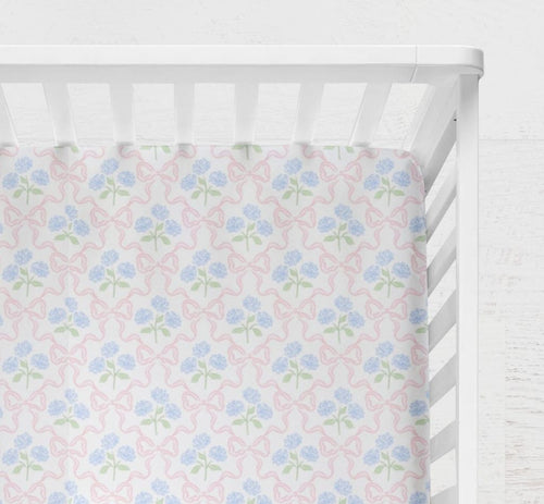 cotton fitted crib sheet featuring a delicate blue hydrangea bouquet accented by a pink bow
Blue Hydrangea Pink Bow Crib Sheet - The Creative Raccoon