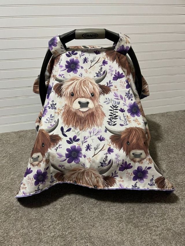 Car seat cover with highland cow design on a neutral background. Car Seat Canopy Highland Cows - The Creative Raccoon
