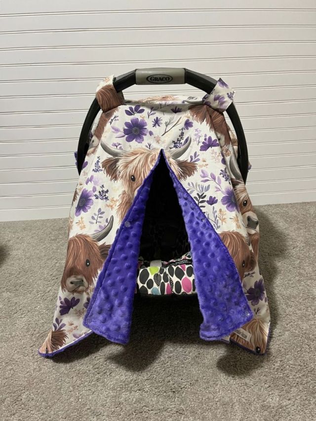 Car seat cover with floral and animal pattern on a plain background. Car Seat Canopy Highland Cows - The Creative Raccoon