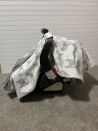 Car seat with a patterned cover against a gray background