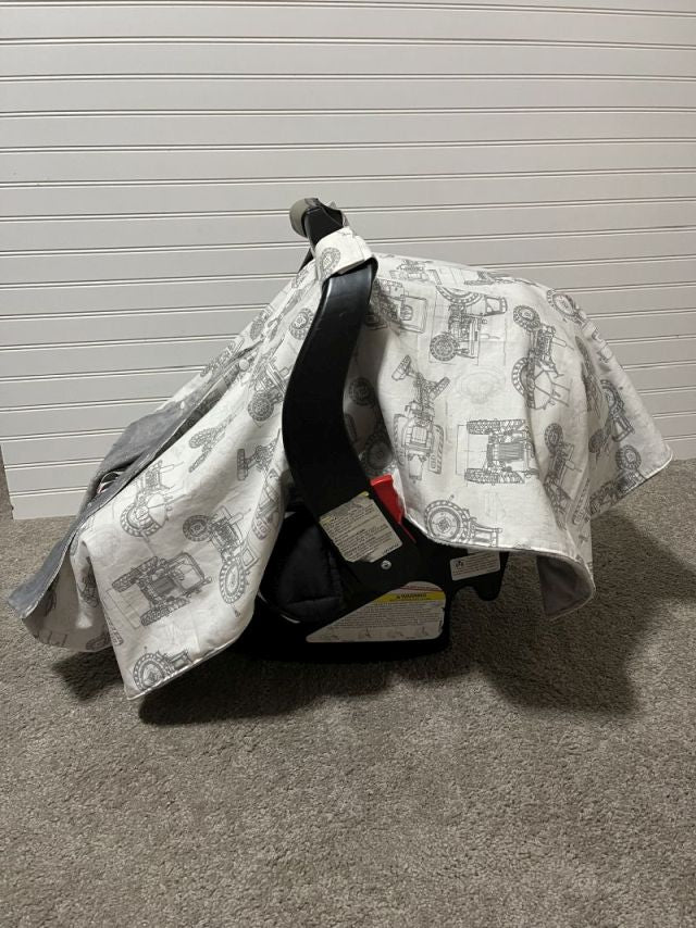 Car seat with a patterned cover against a gray background