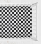 A black and white checkered crib sheet shown from above inside a white crib. Crib Sheet Black and White Checkered - The Creative Raccoon