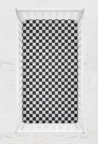 Checkered black and white crib sheet on a crib with a light gray background
Crib Sheet Racing Check - The Creative Raccoon
