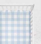 Crib with a blue and white checkered sheet on a light gray background
Light Blue Gingham Crib Sheet - The Creative Raccoon