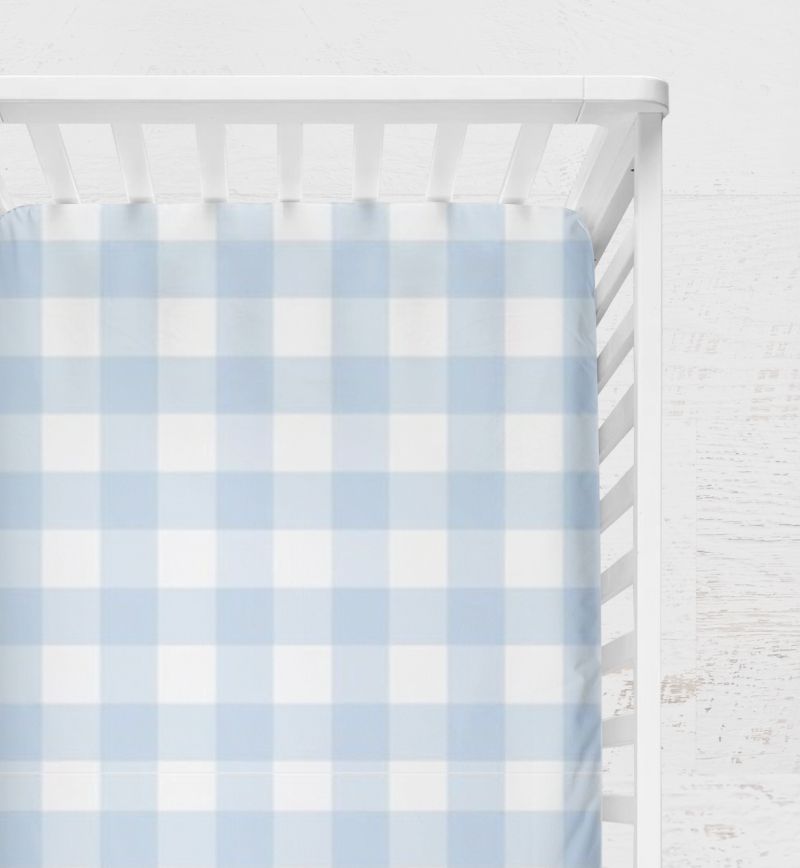 Crib with a blue and white checkered sheet on a light gray background
Light Blue Gingham Crib Sheet - The Creative Raccoon