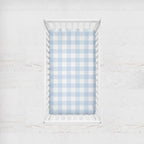 Crib with a blue and white checkered sheet on a light gray background
Light Blue Gingham Crib Sheet - The Creative Raccoon