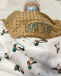 Baby wrapped in a blanket with 'Emerson' embroidered on a blanket with mallard ducks. Mallard Duck Baby Blanket - The Creative Racoon