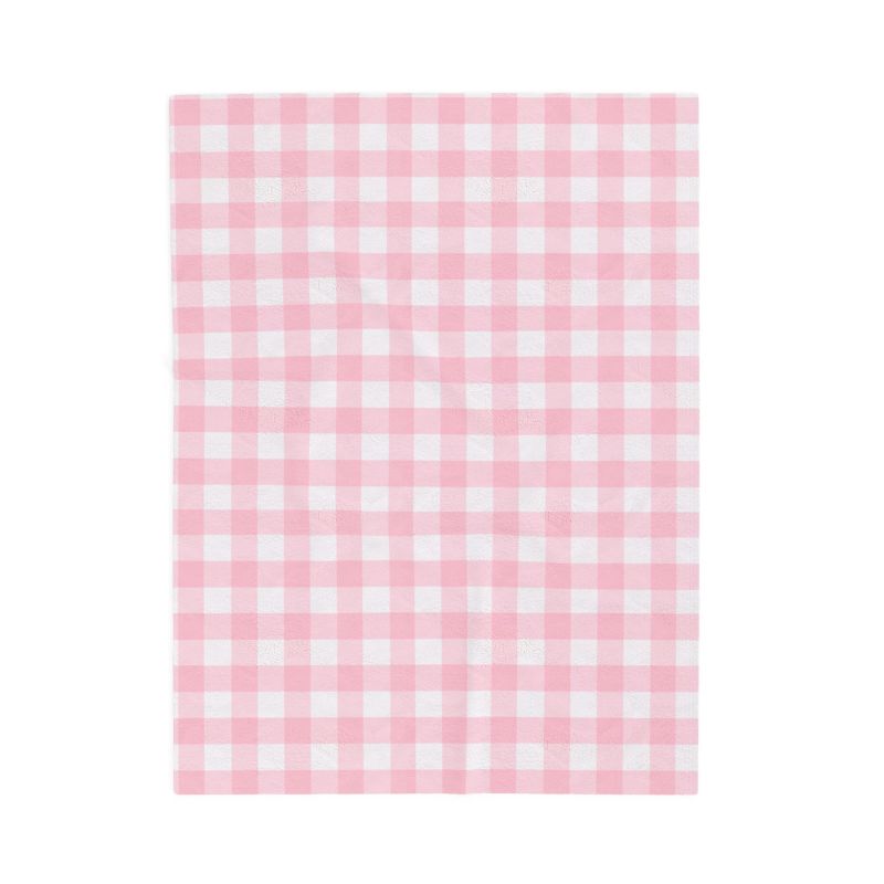 A rectangular pink and white gingham checkered fabric blanket, shown flat against a solid white background.