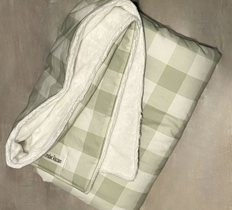 Sage green and creamy white checkered cotton blanket with white raised-dot backing