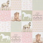 Patchwork pattern with horses, boots, and floral elements on a pink background.
Wildflower Horse Baby Blanket - The Creative Raccoon